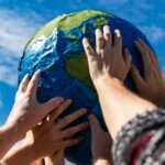 Close up of hands holding terra globe - tah media