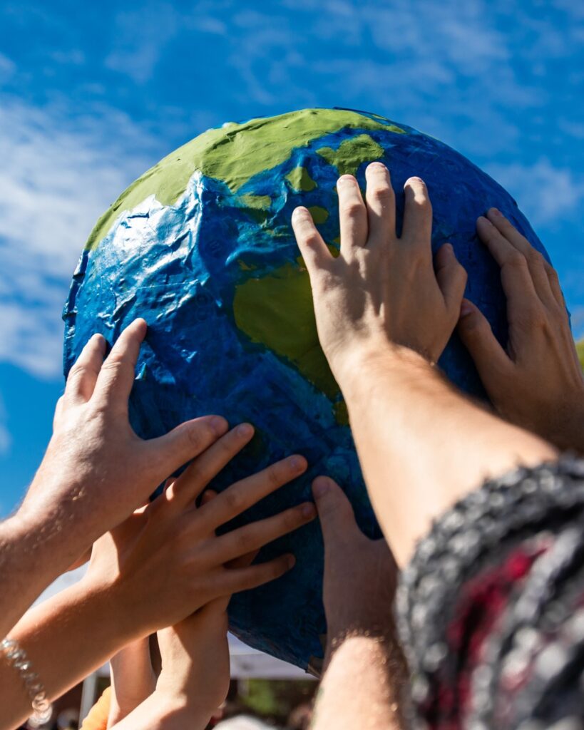 Close up of hands holding terra globe - tah media